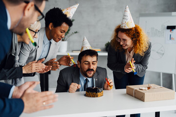 Business Colleagues Celebrating a Birthday with a Cake in the Office