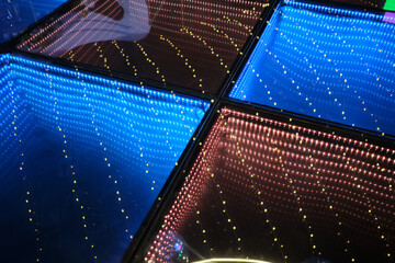 Infinity mirror creating abstract blue and red light illusion