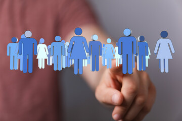 Conceptual image of a group of people, with a finger pointing. Represents teamwork, community, and connection for business or social media use.