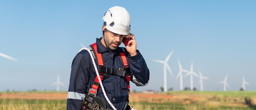 Engineers inspect wind turbine systems to ensure efficient electricity generation from clean, renewable energy. - Powered by Adobe