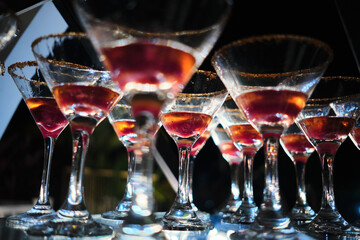 Cocktails lined up with sugar rims during a party