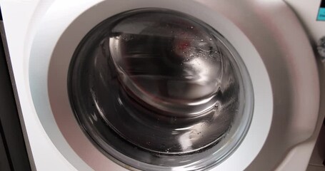 Close up shot of an empty washing machine drum spinning rapidly. Modern household appliance performing a high-speed spin cycle. Perfect for laundry, home, and technology concepts