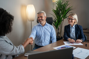 Diverse business people shaking hands after a successful business meeting