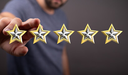 A person's hand reaching out to hold five golden stars. Symbolizing feedback, rating, quality, and customer satisfaction. Perfect for business,