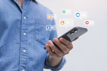 close up young man hand hold smartphone to check feed and notification on social media network...