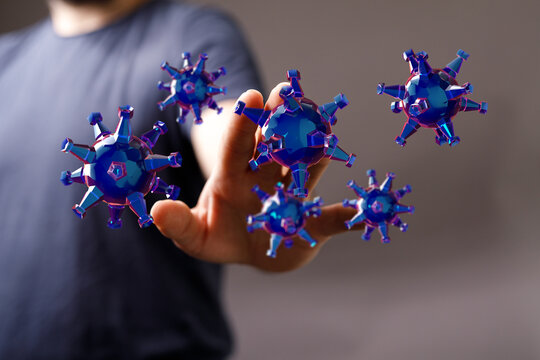 Concept image of a hand touching virus molecules, emphasizing the fight and fear of pandemics and infectious d