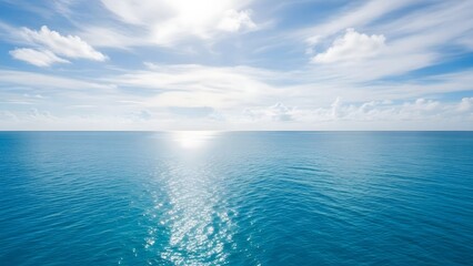Obraz premium Calm Blue Ocean Under Bright Sunlit Sky with Fluffy Clouds