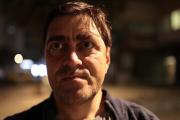 Man showing worried intense expression at night