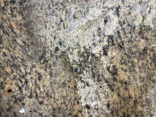 Close up of random brown marble or granite with black and beige grains. Minerals stone texture, natural marble or granite. Seamless background texture.