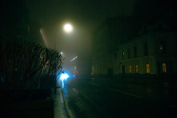 Street lights in mist. Autumn night with rain in the city