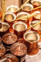 Traditional copper cezve set with ornate coffee cups