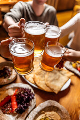 Friends toasting beer over tatar halal feast