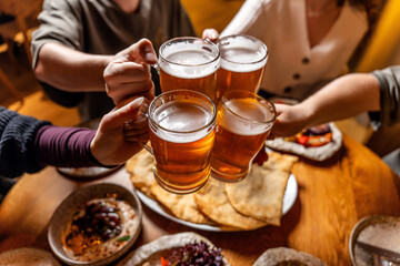Friends cheering beer over tatar halal feast