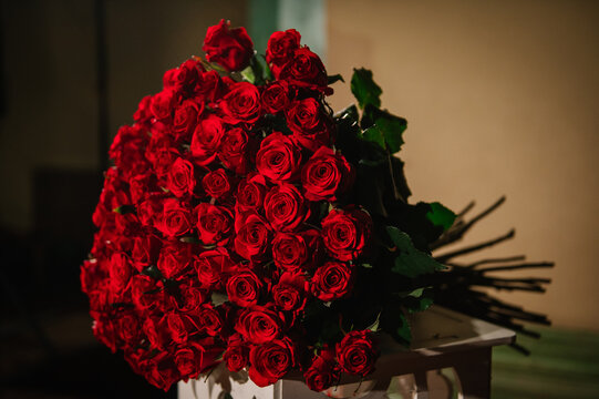 101 roses. Large bouquet of red roses for surprise and congratulate. Luxury romantic date. Candlelight for a couple on Valentine's day. Location for a surprise marriage proposal at night. - Powered by Adobe
