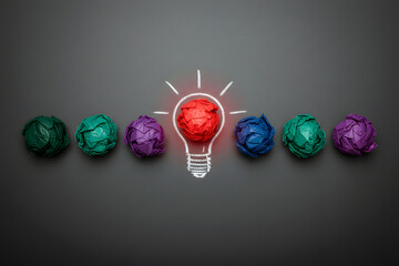 Innovation: red crumpled paper ball inside a chalk lightbulb.