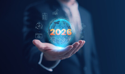A businessman holding a holographic globe with 2026 surrounded by productivity, workflow, planning, and task management icons, symbolizing organization efficiency and business performance in 2026.