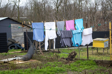 Clothes drying on outdoor clothesline in backyard, representing daily chores and simple life in a rural setting