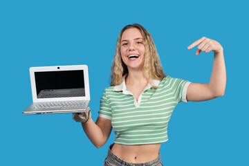 Young woman presenting laptop smiling and pointing