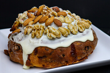 Traditional Argentine Pan Dulce dark food style with glaze and dried fruit