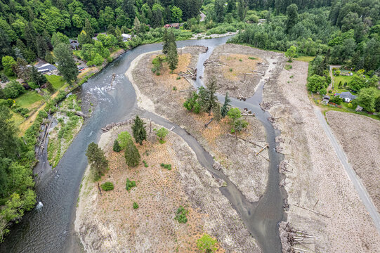 Aerial view of the river meandering through the landscape, with sandbars and lush forests creating a stunning contrast of textures and colors, Oregon, United States.