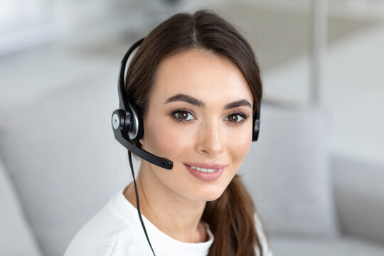 Woman in a white shirt is wearing a headset