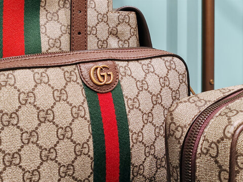 Cannes, France - June 7, 2025: Close-up of luxury Gucci handbags with GG monogram and red green web stripe displayed inside boutique on La Croisette