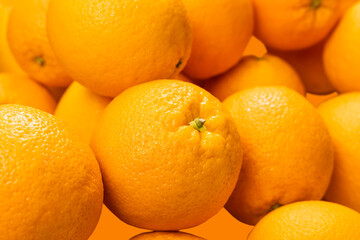 Background image: Fresh, ripe, large oranges of the new crop in a store