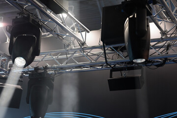 lighting fixtures hanging on truss over the stage