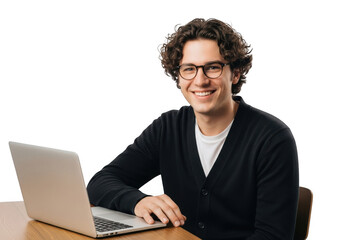Smiling man with curly hair wearing glasses and a dark cardigan sits at a wooden desk with a laptop isolated on transparent background