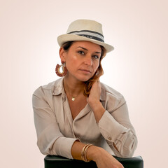 Elegant woman in fedora hat posing on neutral background