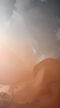 Textured abstract sand dunes with soft light and atmospheric clouds