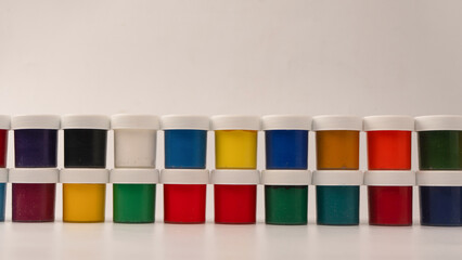 Gouache colorful paints set. Jars of gouache paint isolated on a white background.