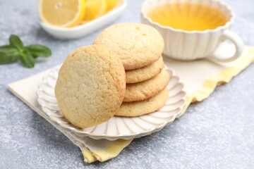 Tasty lemon cookies on grey table, closeup