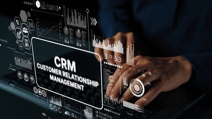 Hands Typing on Laptop with CRM Customer Relationship Management Graphics Overlay in Modern Office Environment. Asymptotic smart data analytic.