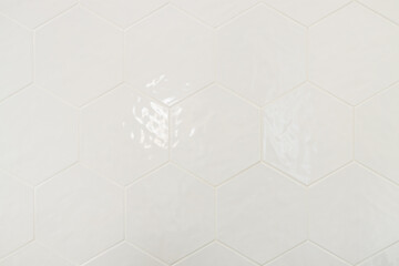 Clean minimal close-up of white hexagonal tile surface with subtle gloss and gentle light...