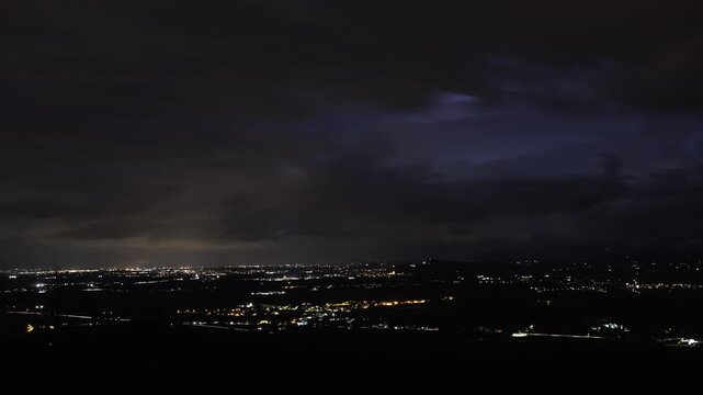 video timelapse di un'intenso temporale notturno estivo, con fulmini, che passa rapidamente sopra la pianura e le colline della regione Friuli Venezia Giulia, in Italia