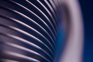 Abstract metallic diagonal curves with pink neon light on a dark blue background. Modern industrial luxury design for presentation with copy space. Photo