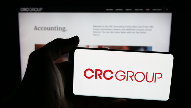 Stuttgart, Germany - 11-28-2025: Person holding mobile phone with logo of US company CRC Insurance Services LLC on screen in front of web page. Focus on phone display.