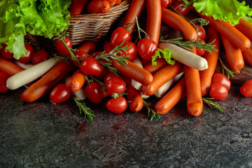 Various thin smoked sausages with salad, tomatoes, and rosemary.