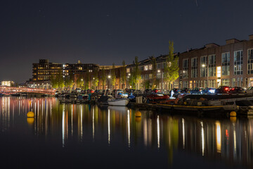 Colorful night view reflected on canal Amsterdam