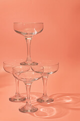 Stacked glass dessert bowls on a peach background during a food presentation at a gathering