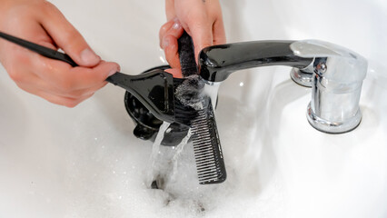 Barber tools cleaning in modern barbershop sink