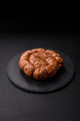 Grilled sausage in the shape of a spiral or snail, from chicken or pork. Spiral or snail sausage