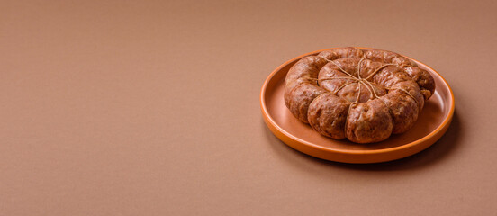 Grilled sausage in the shape of a spiral or snail, from chicken or pork. Spiral or snail sausage
