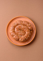 Grilled sausage in the shape of a spiral or snail, from chicken or pork. Spiral or snail sausage