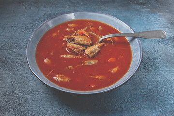 French shrimp bisque soup, in a plate, on a blue background, close-up, no people,