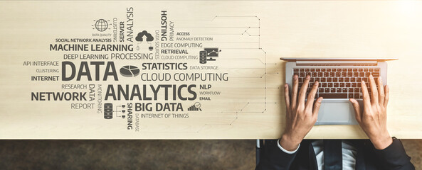 A professional workspace showcasing hands typing on a laptop surrounded by various data analytics concepts. This image emphasizes technology role in modern research and business. Tessel