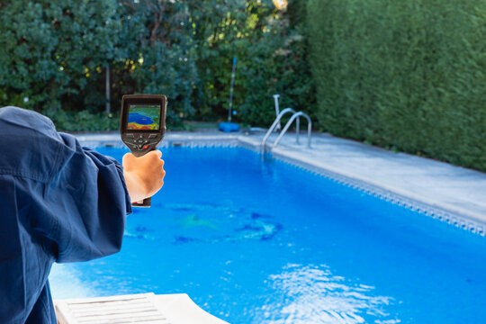 Technician detecting swimming pool leak with thermal camera