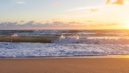 Golden sunset over ocean waves rolling onto a sandy beach, perfect for travel, summer vacation, relaxation, nature backgrounds, and tranquil seaside concepts.