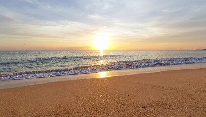 Peaceful beach at sunrise with golden sunlight over the ocean and sandy shore, ideal for travel, nature backgrounds, relaxation themes, and tranquil summer concepts.